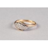 18ct GOLD AND PLATINUM CROSS-OVER RING with three tiny diamonds, in star settings, 2.8gms