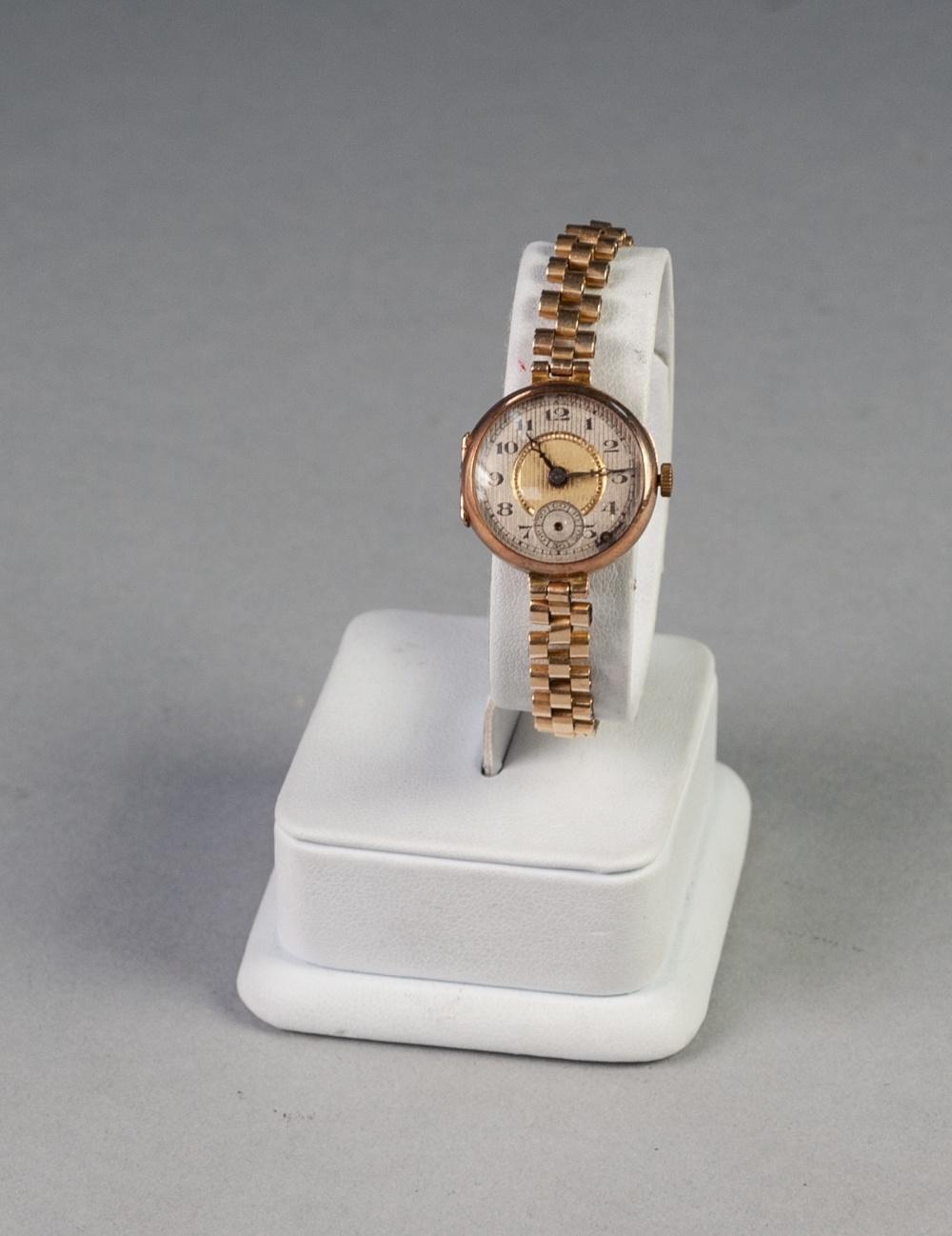 a 9ct GOLD LADY'S WRIST WATCH, on rolled gold linked bracelet (seconds hand detached)