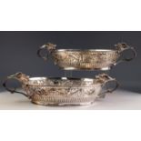 GEORGE VI IMPRESSIVE PAIR OF EMBOSSED AND PIERCED SILVER TWO HANDLED DISHES, each of oval form