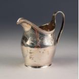 GEORGE III ENGRAVED SILVER CREAM JUG, of oval baluster form with reeded scroll handle and bright cut