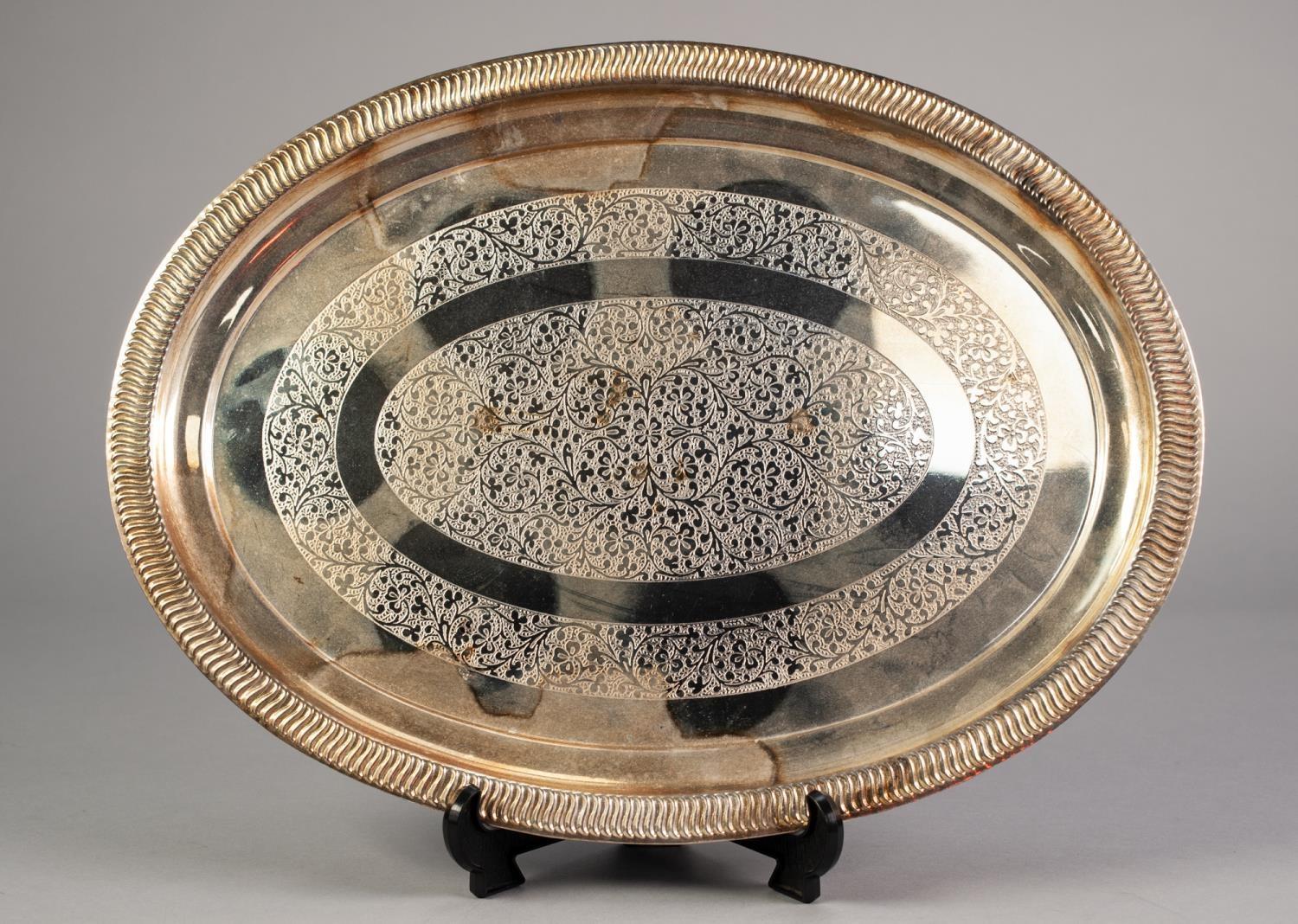 INDIAN ENGRAVED SILVER COLOURED METAL TRAY, of oval form with floral centre and border, unmarked, 15