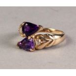 9ct GOLD CROSS-OVER RING set with two tear shaped amethysts and two small round brilliant cut