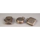 TWO ENGRAVED SILVER VESTA CASES, together with an ENGINE TURNED SILVER HALF SOVEREIGN HOLDER, all