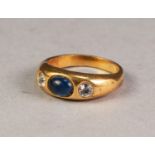 VICTORIAN GOLD COLOURED METAL RING set with a cabochon oval blue stone flanked by two white