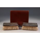 GEORGE V CASED PAIR OF ENGINE TURNED SILVER BACKED MILITARY HAIR BRUSHES, monogrammed, Birmingham