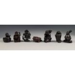 SEVEN VARIOUS TWENTIETH CENTURY JAPANESE WELL CARVED DARK HARDWOOD NETSUKE, (7)