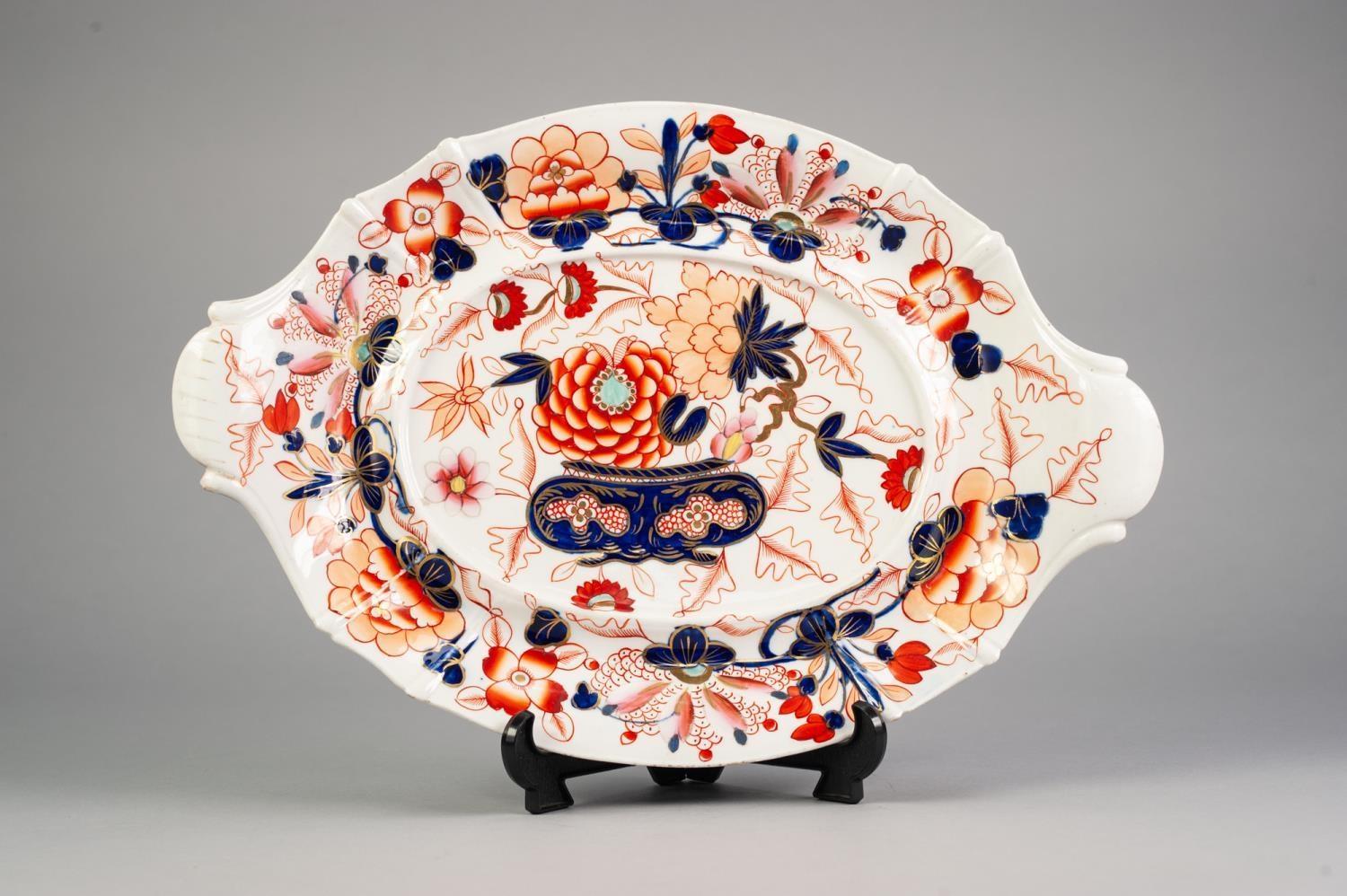 NINETEENTH CENTURY ENGLISH IMARI PORCELAIN TWO HANDLED TUREEN STAND, of oval form with raised border