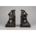 PAIR OF INTER-WAR YEARS 'BRONZED' SPELTER AND IVORINE FIGURAL BOATENDS, on serpentine marble