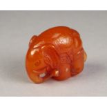 LATE NINETEENTH CENTURY JAPANESE CARVED AMBER NETSUKE, modelled as a caparisoned elephant, signed,