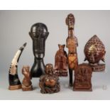 COLLECTION OF SEVEN EASTERN AND AFRICAN CARVED WOODEN FIGURES, including, an ORIENTAL RED WOOD