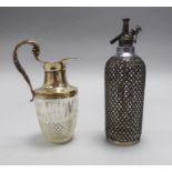 SODA SYPHON IN ELECROPLATED LATTICE WORK HOLDER, and a CUT GLASS CLARET JUG WITH ELECTROPLATED