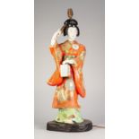 EARLY 20th CENTURY JAPANESE PORCELAIN BIJEN FIGURE HOLDING A FAN AND A LANTERN, colourfully