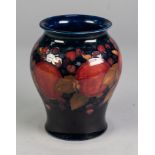 WILLIAM MOORCROFT POTTERY INVERTED BALUSTER SHAPE VASE, pomegranate and berry decorated, on a dark