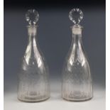 PAIR OF NINETEENTH CENTURY CUT GLASS DECANTERS AND STOPPERS, each of bottle form with disc shaped