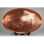 HAROLD HOLMES PLANISHED COPPER TRAY, of oval form, with floral engraving to the ends, impressed