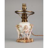 EARLY TWENTIETH CENTURY GERMAN FIGURAL AND FLORAL ENCRUSTED PORCELAIN TABLE LAMP BASE, painted in