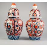 PAIR OF JAPANESE LATE MEIJI PERIOD IMARI PORCELAIN JARS AND COVERS, each of lobated ovoid form