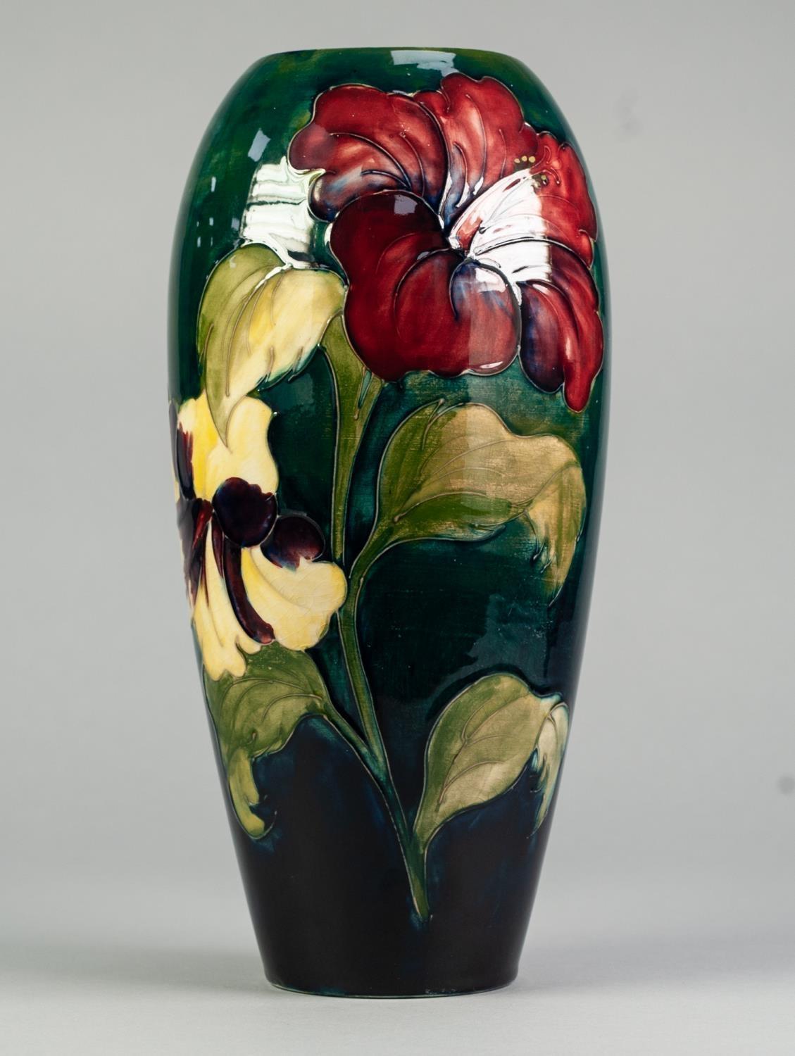 WALTER MOORCROFT HIBISCUS PATTERN TUBE LINED POTTERY VASE, of slender ovoid form, painted in tones