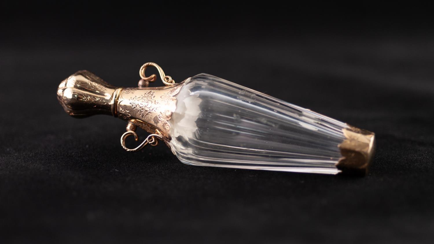 A LATE 19TH CENTURY FRENCH FACETED CLEAR GLASS AND GOLD COLOURED METAL MOUNTED SCENT BOTTLE