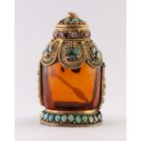 AN AMBER COLOURED GLASS GILT METAL MOUNTED AND FAUX GEMSTONE SET SNUFF BOTTLE, 3" (7.5cm) high
