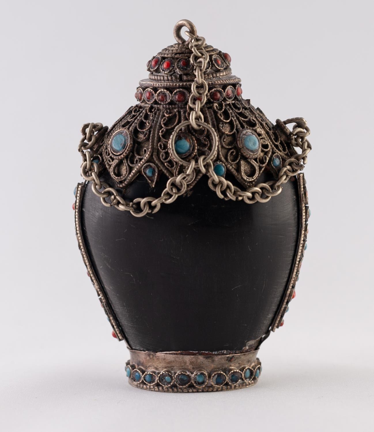 A POSSIBLY HORN, WHITE METAL AND FAUX JEWEL ENCRUSTED SNUFF BOTTLE, with chain attached stopper