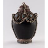 A POSSIBLY HORN, WHITE METAL AND FAUX JEWEL ENCRUSTED SNUFF BOTTLE, with chain attached stopper