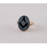 SARDONYX MASONIC INTAGLIO RING. An oval plaque with engraved Masonic motif, to forked shoulders,