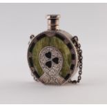 AN EDWARDIAN SILVER GREEN-STONE INSET AND BLACK JAPANNED HORSE-SHOE SHAPED SCENT FLASK, centred with