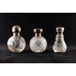 THREE EARLY 20TH CENTURY ORBICULAR AND PEAR SHAPED CUT AND WHEEL ENGRAVED SILVER TOPPED SCENT