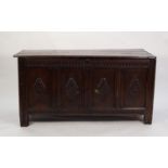 LATE SEVENTEENTH CENTURY CARVED OAK COFFER, the three plank top above a four panelled front, each