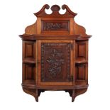 LATE VICTORIAN CARVED WALNUT WALL CUPBOARD, the swan neck pediment above a floral carved panel and