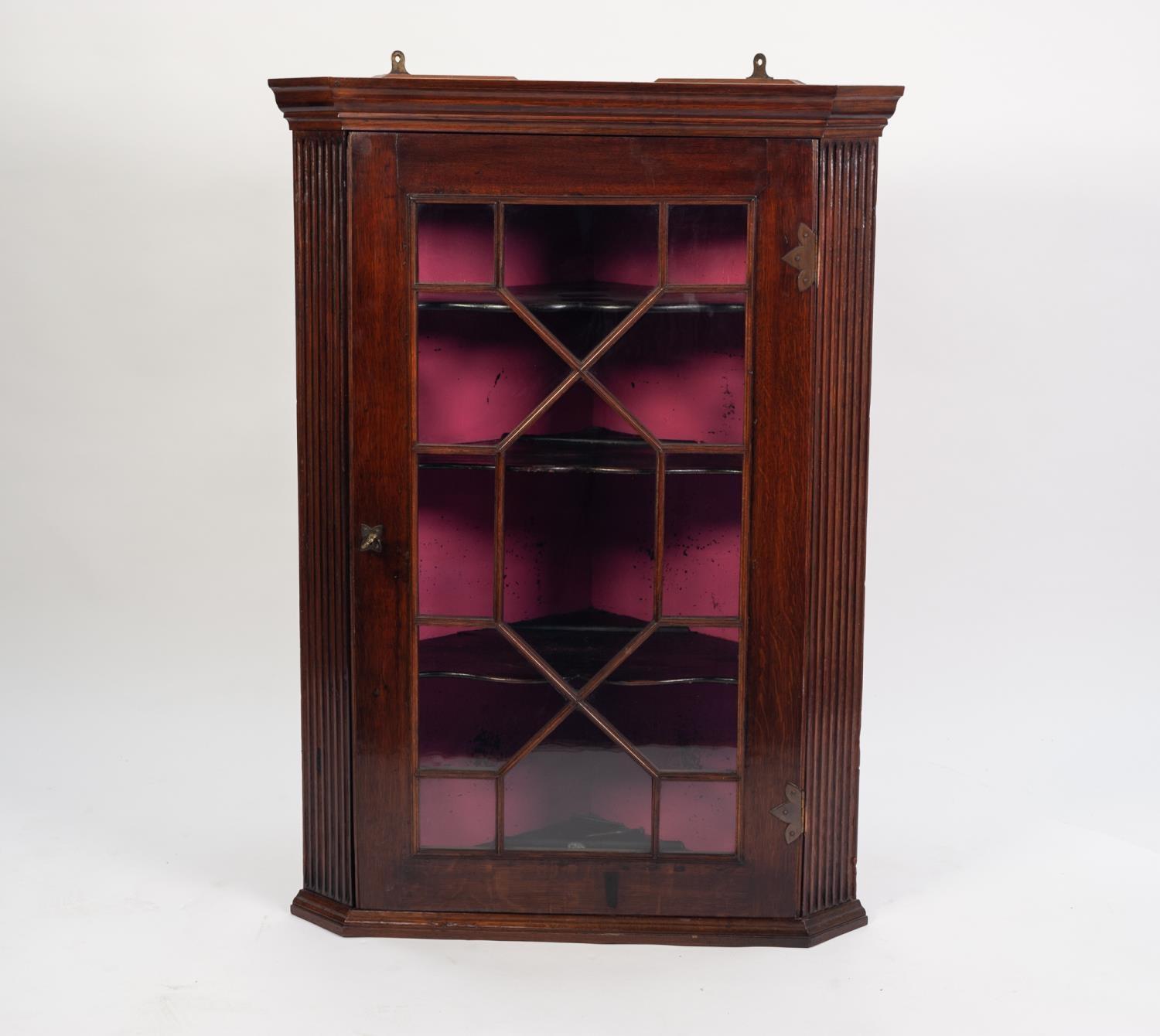 GEORGIAN STYLE MAHOGANY AND OAK CORNER CUPBOARD, the moulded cornice above fluted uprights and a