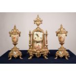 20th CENTURY FRENCH STYLE GILT METAL AND PORCELAIN CLOCK GARNITURE OF THREE PIECES, the clock with