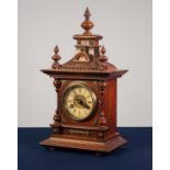 LATE NINETEENTH/ EARLY TWENTIETH CENTURY CARVED WALNUT MANTLE CLOCK, the 3 ¾? two part Roman dial