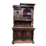 LATE NINETEENTH/ EARLY TWENTIETH CENTURY CONTINENTAL CARVED WALNUT HUNTER?S CABINET, the top section