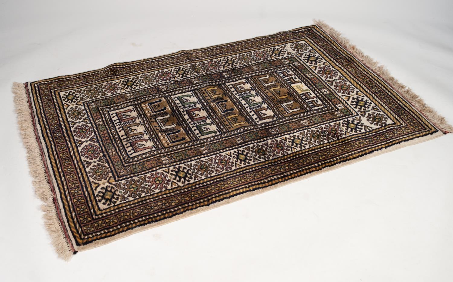 EASTERN RUG, the central rectangular panel with ladder stripes decorated with rows of stylised