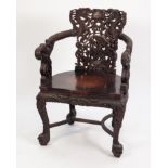 TWENTIETH CENTURY CHINESE CARVED REDWOOD OPEN ARMCHAIR, of tub form with outswept arms, serpentine