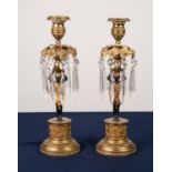 PAIR OF REGENCY PATINATED AND GIT BRONZE FIGURAL CANDLESTICKS, each modelled a Blackamoor supporting