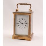EARLY 20th CENTURY FRENCH CORNICHE CASED BRASS CARRIAGE CLOCK, the white enamel dial with roman hour