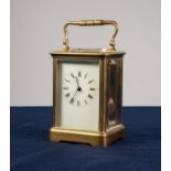 EARLY TWENTIETH CENTURY BRASS CASED REPEATING CARRIAGE CLOCK, of typical form with raised oval