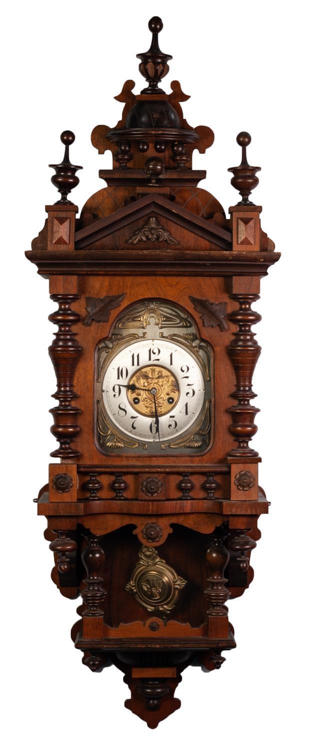 LATE 19th/EARLY 20th CENTURY GERMAN WALNUT WALL CLOCK, the pendulum movement striking on a coiled