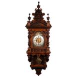 LATE 19th/EARLY 20th CENTURY GERMAN WALNUT WALL CLOCK, the pendulum movement striking on a coiled