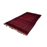 TURKOMAM BOKHARA small carpet with five rows of primary guls on a wine red field 10' x 5' 8"