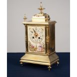 EARLY TWENTIETH CENTURY BRASS AND HAND PAINTED PORCELAIN MANTLE CLOCK, the oblong Arabic dial with