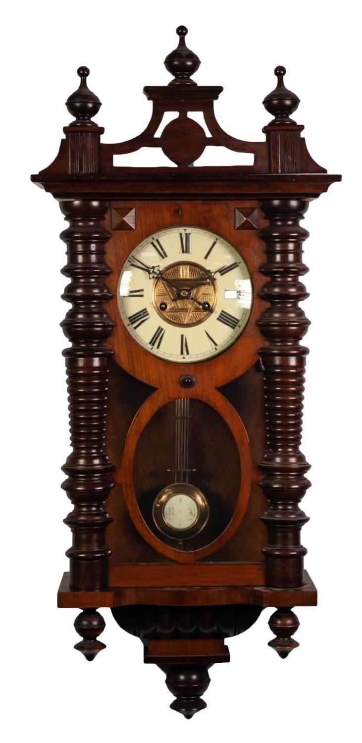 LATE 19th CENTURY WALNUT AND BEECHWOOD CASED VIENNA STYLE WALL CLOCK with pendulum, finialed