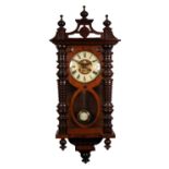 LATE 19th CENTURY WALNUT AND BEECHWOOD CASED VIENNA STYLE WALL CLOCK with pendulum, finialed
