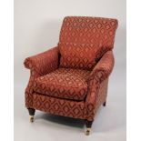 A mid 20th Century padded armchair, having scroll back and arms, raised on mahogany turned front