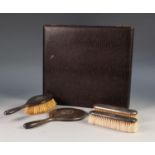 GEORGE V FOUR PIECE SILVER BACKED COMMEMORATIVE DRESSING TABLE HAND MIRROR AND BRUSH SET, with