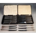 TWO BOXED SETS OF AFTERNOON TEA KNIVES with silver handles in plush lined and fitted boxes and an