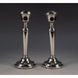 PAIR OF GEORGIAN STYLE MODERN WEIGHTED SILVER CANDLESTICKS, each of plain tapering from with urn